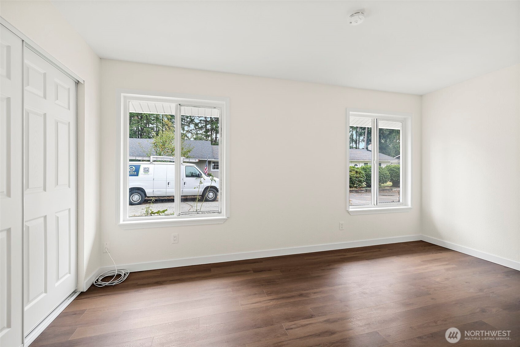 19250 Southeast 268th Street Covington, WA 98042 - Photo 17 of 37 a view of an empty room with wooden floor and a window
