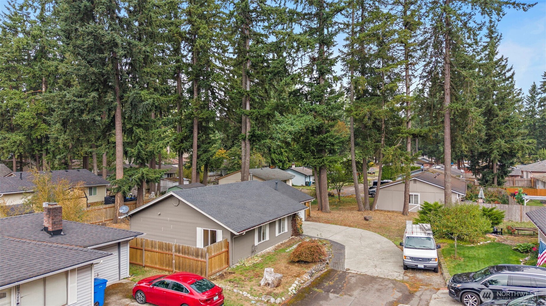 19250 Southeast 268th Street Covington, WA 98042 - Photo 36 of 37 a view of house with yard outdoor seating and trees in the background