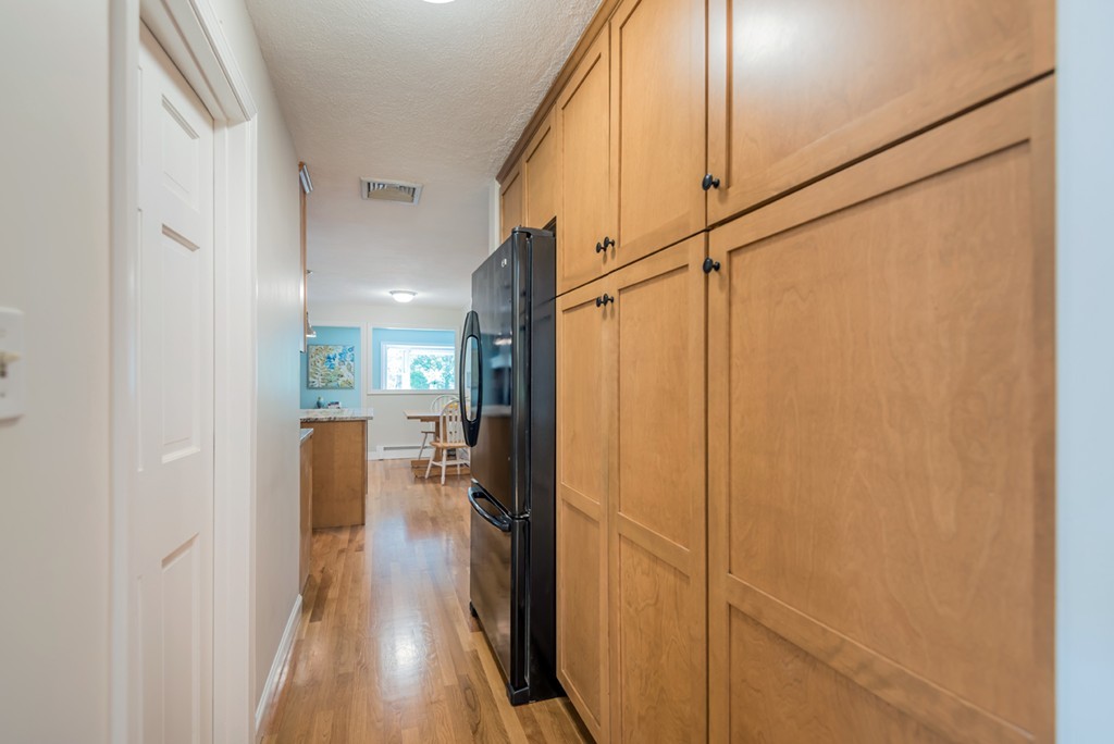 125 Rattlesnake Hill Road Andover, MA 01810 - Photo 11 of 28 a view of a hallway with wooden floor and staircase