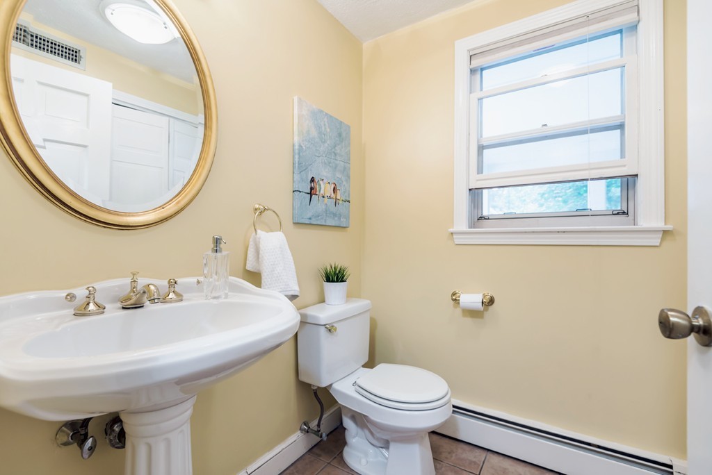 125 Rattlesnake Hill Road Andover, MA 01810 - Photo 15 of 28 a bathroom with a sink a mirror a toilet and a window