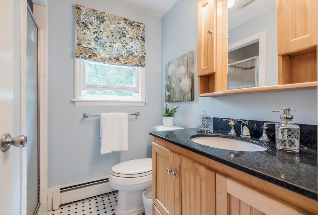 125 Rattlesnake Hill Road Andover, MA 01810 - Photo 19 of 28 a bathroom with a granite countertop sink and a toilet