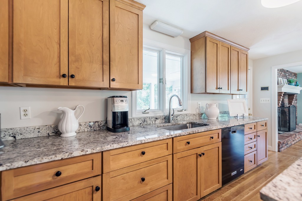 125 Rattlesnake Hill Road Andover, MA 01810 - Photo 9 of 28 a kitchen with granite countertop white cabinets and sink