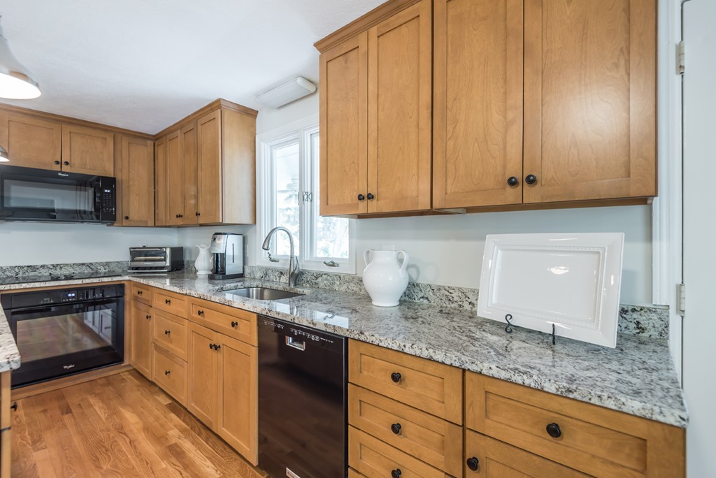 125 Rattlesnake Hill Road Andover, MA 01810 - Photo 10 of 28 a kitchen with granite countertop white cabinets and stainless steel appliances