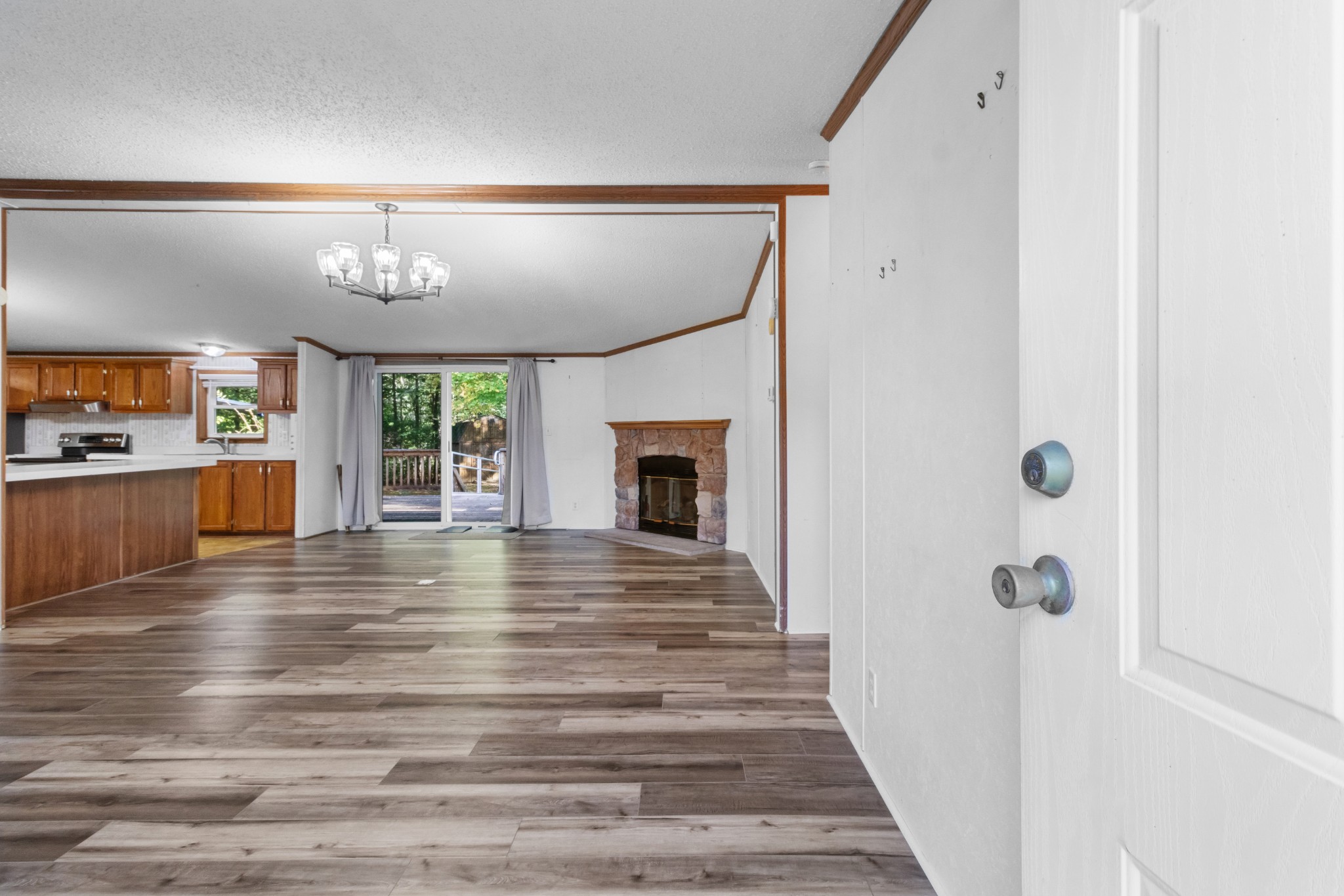 4605 Marion Road Cunningham, TN 37052 - Photo 16 of 45 a view of a hallway with wooden floor and a living room
