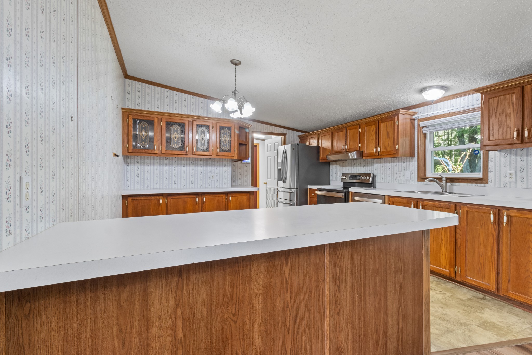 4605 Marion Road Cunningham, TN 37052 - Photo 23 of 45 a kitchen with stainless steel appliances kitchen island granite countertop wooden cabinets a refrigerator and a sink