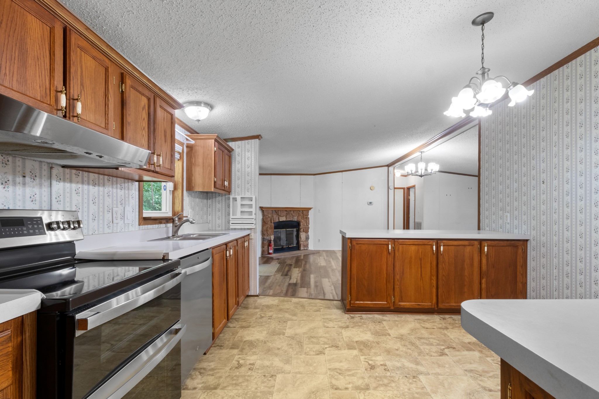 4605 Marion Road Cunningham, TN 37052 - Photo 25 of 45 a kitchen with stainless steel appliances granite countertop a sink a stove and a wooden floors