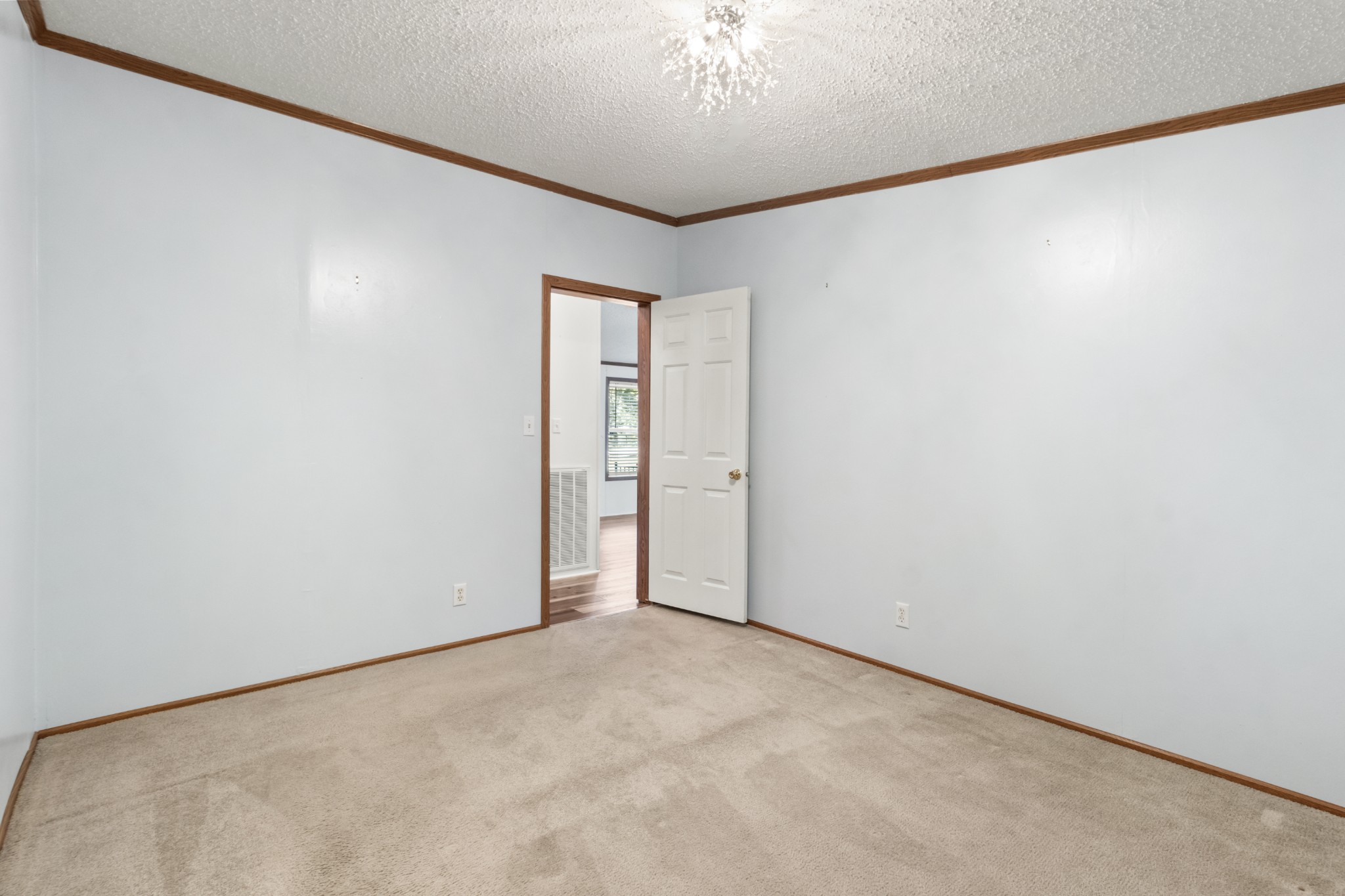 4605 Marion Road Cunningham, TN 37052 - Photo 28 of 45 an empty room with a chandelier fan