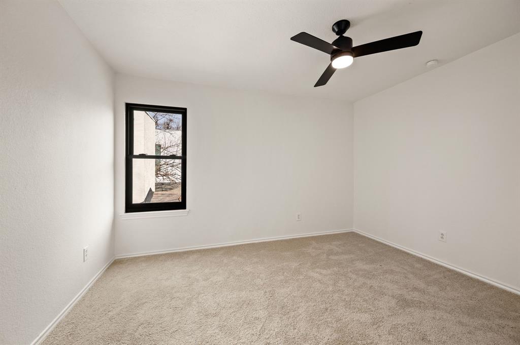 5009 Milam Street Dallas, TX 75206 - Photo 25 of 35 Carpeted spare room featuring a ceiling fan and baseboards
