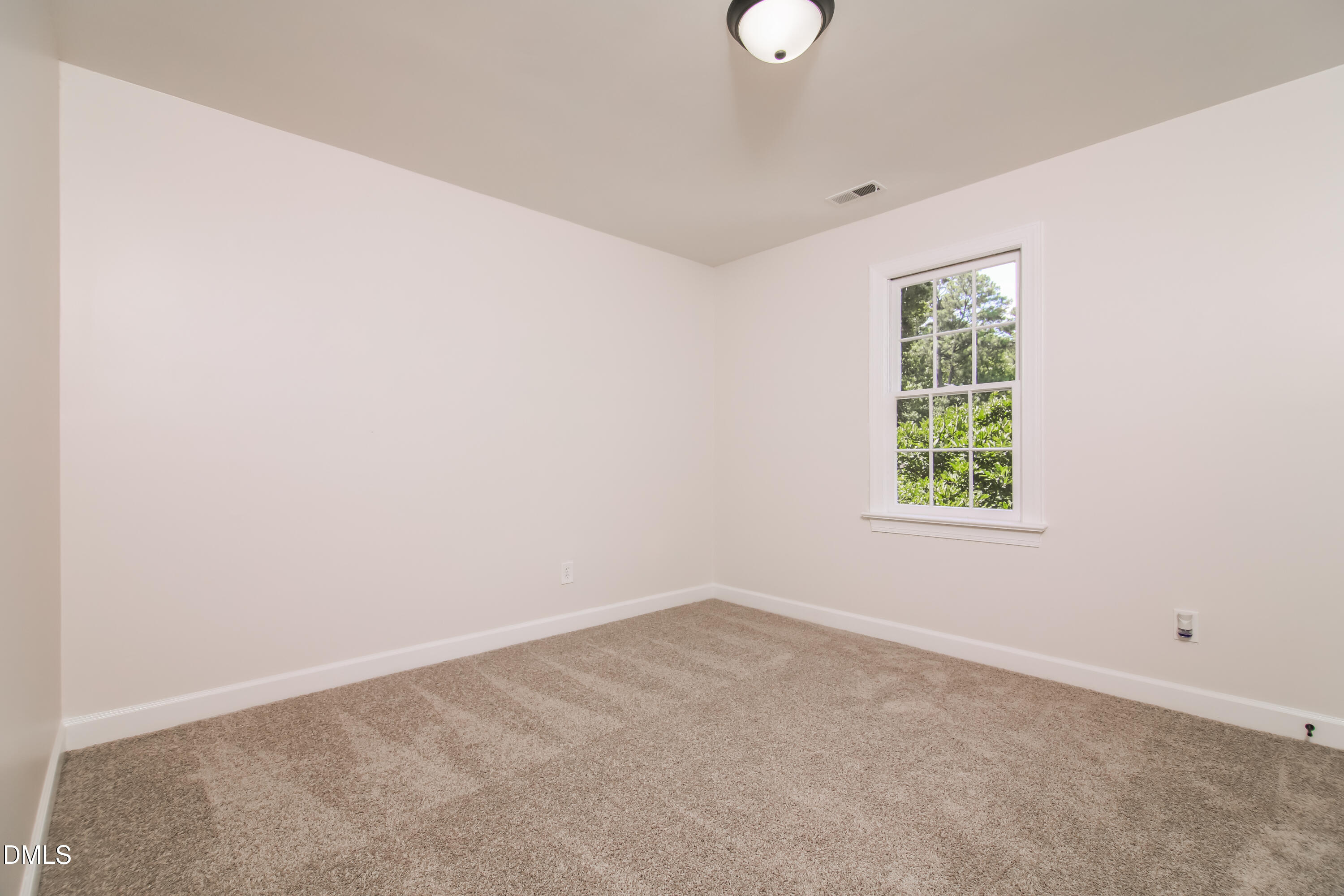 4416 Lancashire Drive Raleigh, NC 27613 - Photo 11 of 15 an empty room with a window