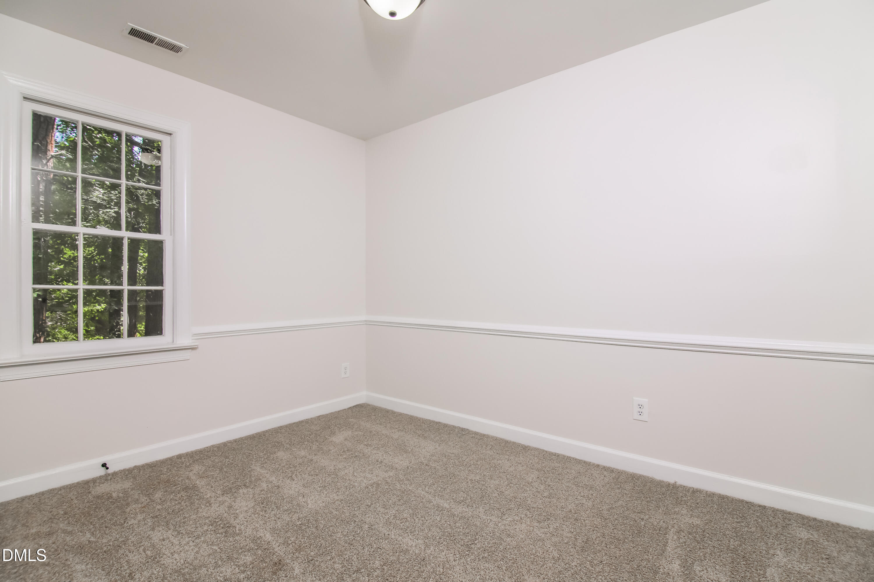 4416 Lancashire Drive Raleigh, NC 27613 - Photo 12 of 15 an empty room with a window