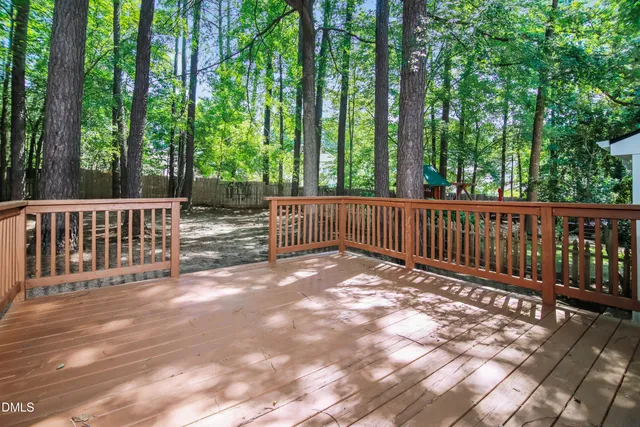 a view of backyard with green space and deck