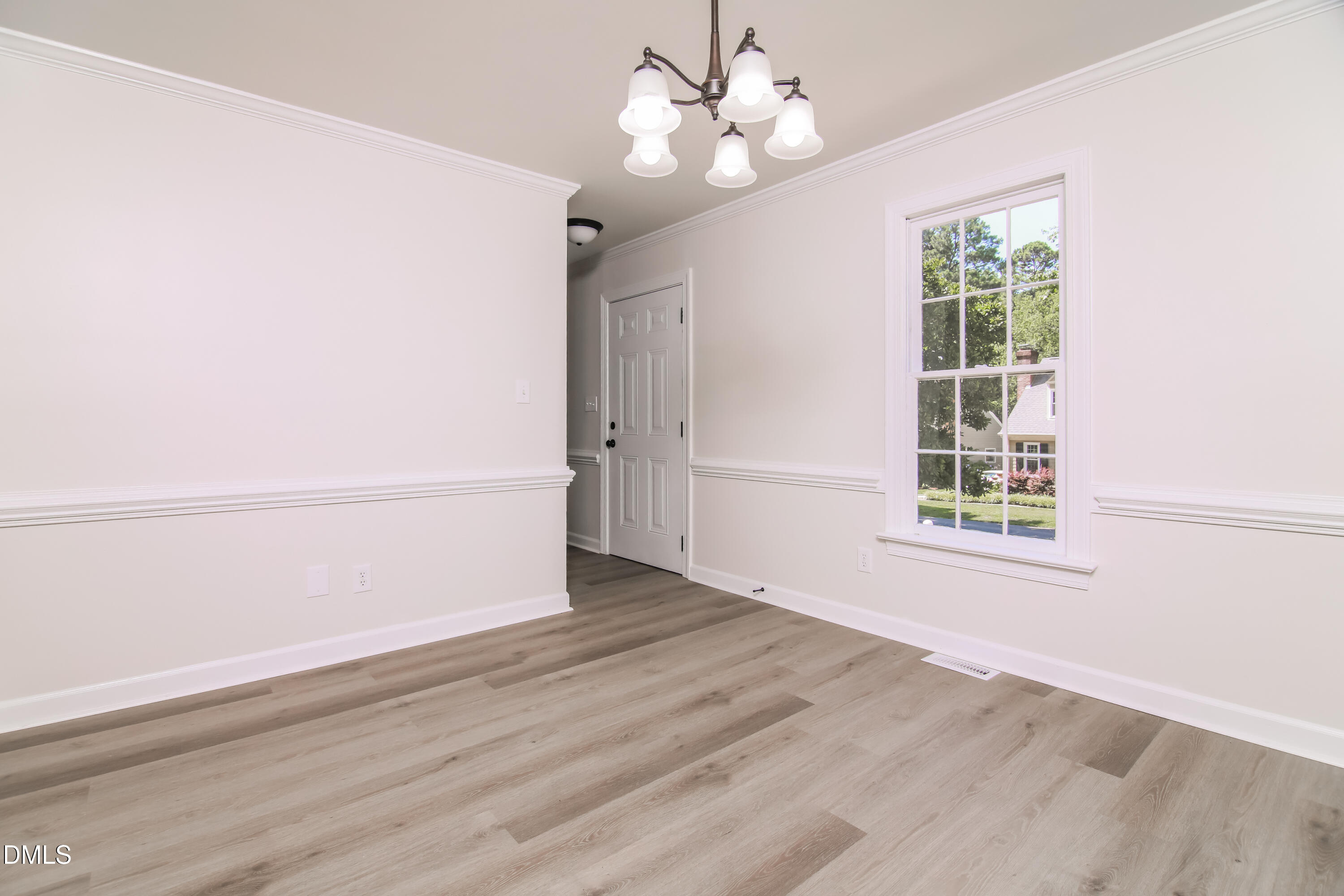 4416 Lancashire Drive Raleigh, NC 27613 - Photo 4 of 15 wooden floor in an empty room with a window