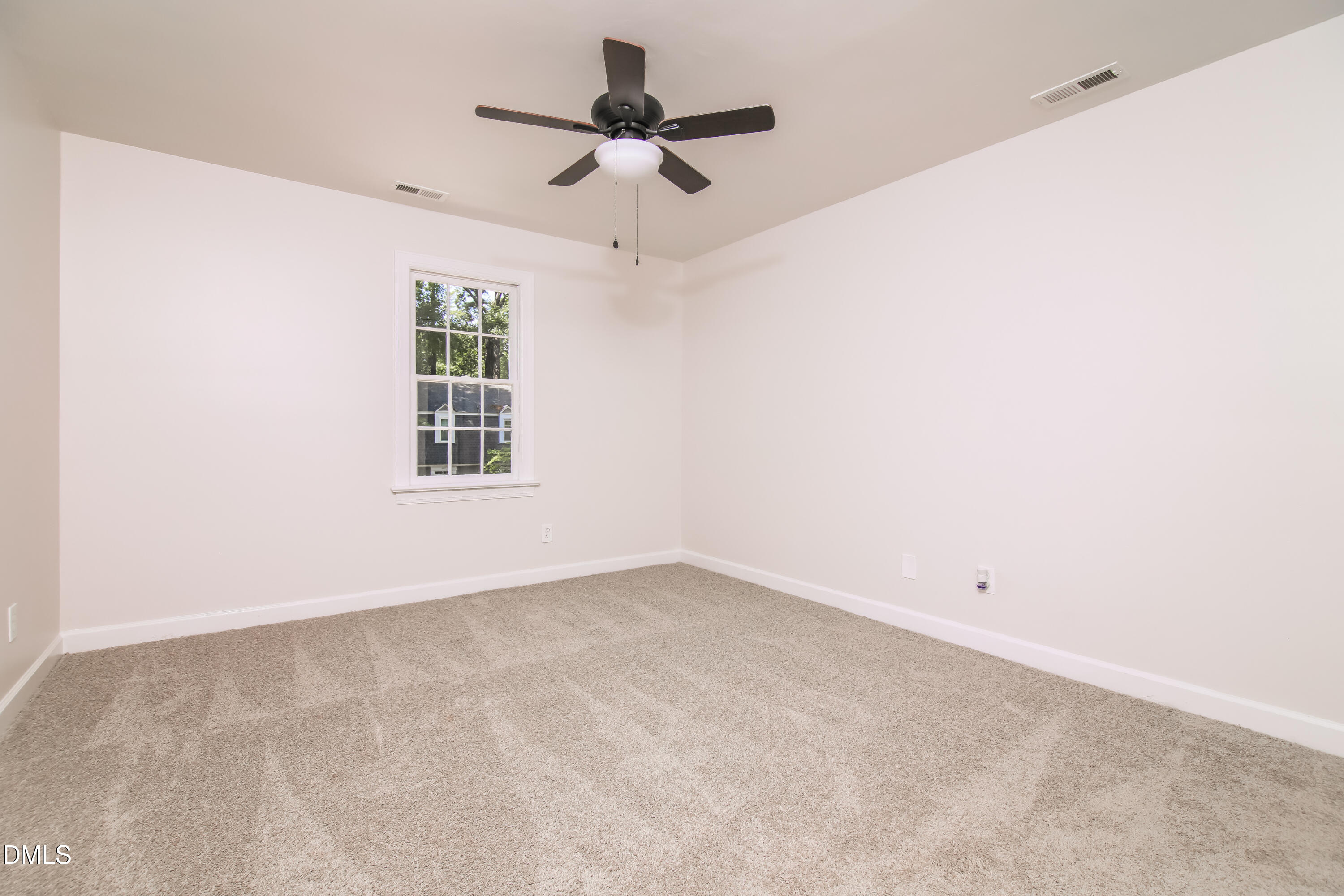 4416 Lancashire Drive Raleigh, NC 27613 - Photo 8 of 15 an empty room with a ceiling fan and window