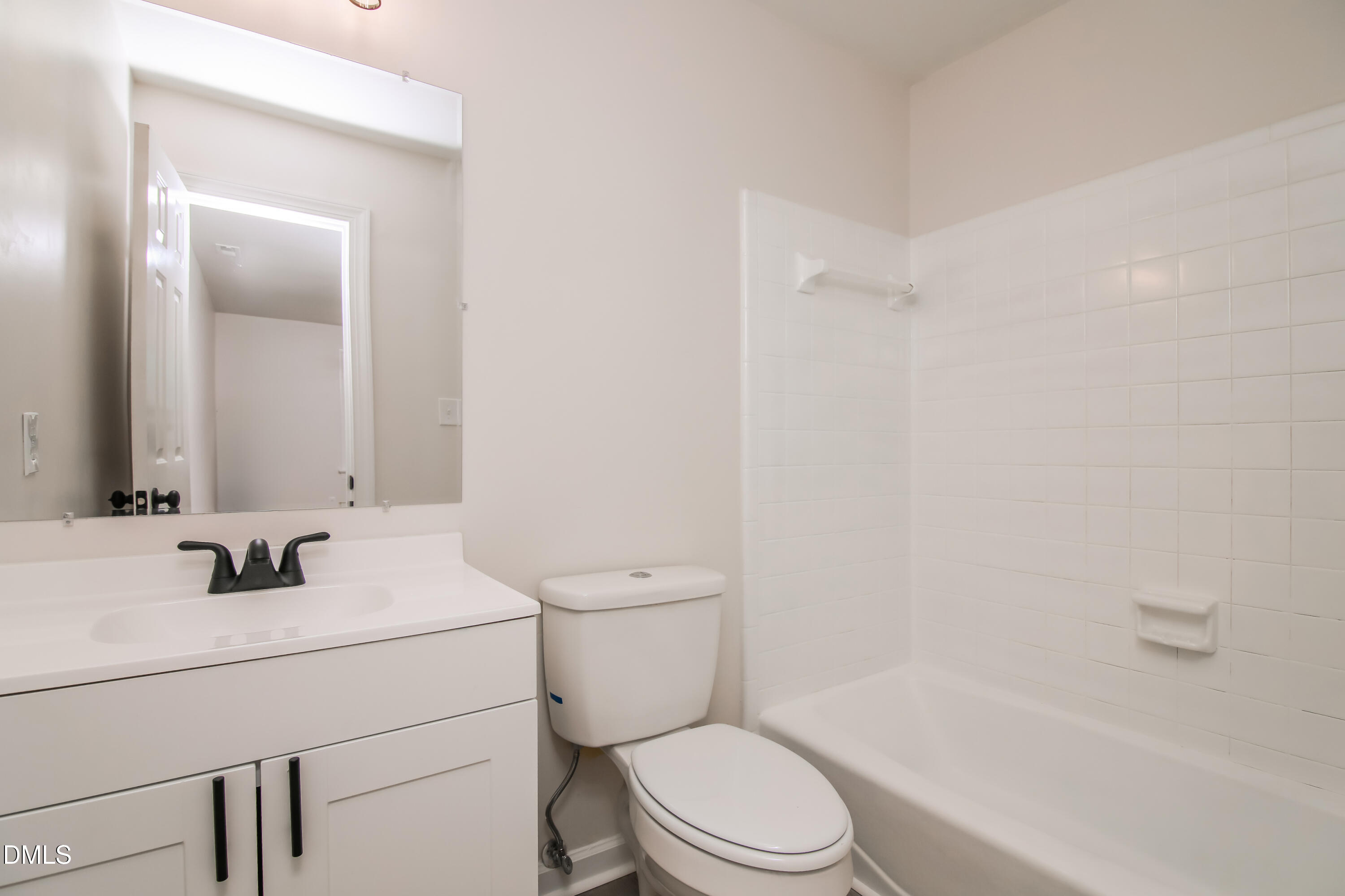 4416 Lancashire Drive Raleigh, NC 27613 - Photo 10 of 15 a bathroom with a sink toilet vanity and shower