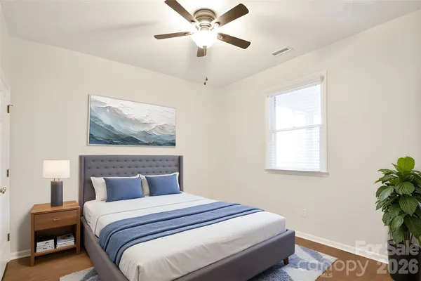 a bedroom with a bed and a painting on the wall