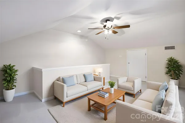 a living room with furniture potted plant and a window
