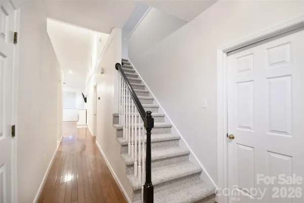 a view of a hallway with wooden floor and entryway