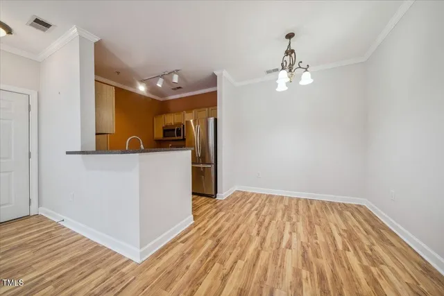 a kitchen with stainless steel appliances a refrigerator and a sink
