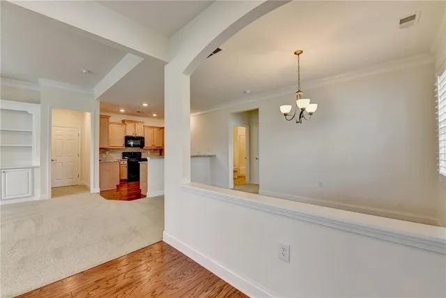 a view of an empty room with a fireplace and a window