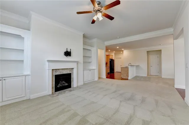 a kitchen with stainless steel appliances kitchen island granite countertop a refrigerator a stove and a sink