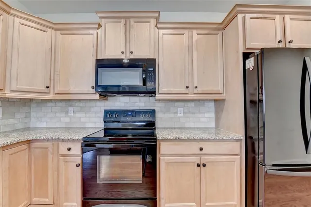 a kitchen with appliances a sink and cabinets