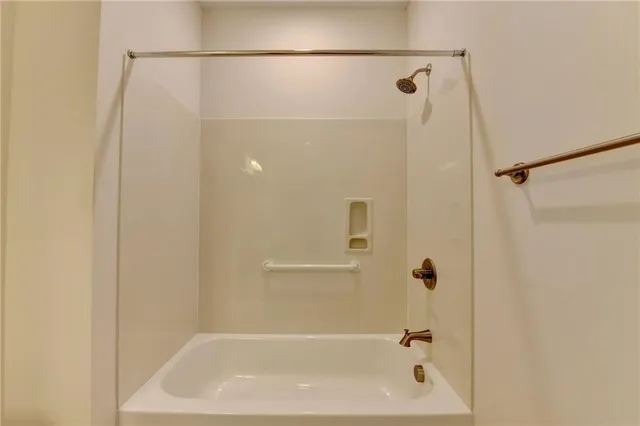 a spacious bathroom with a double vanity sink a large mirror and a shower