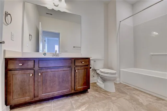 a bathroom with a granite countertop sink a large mirror and a shower