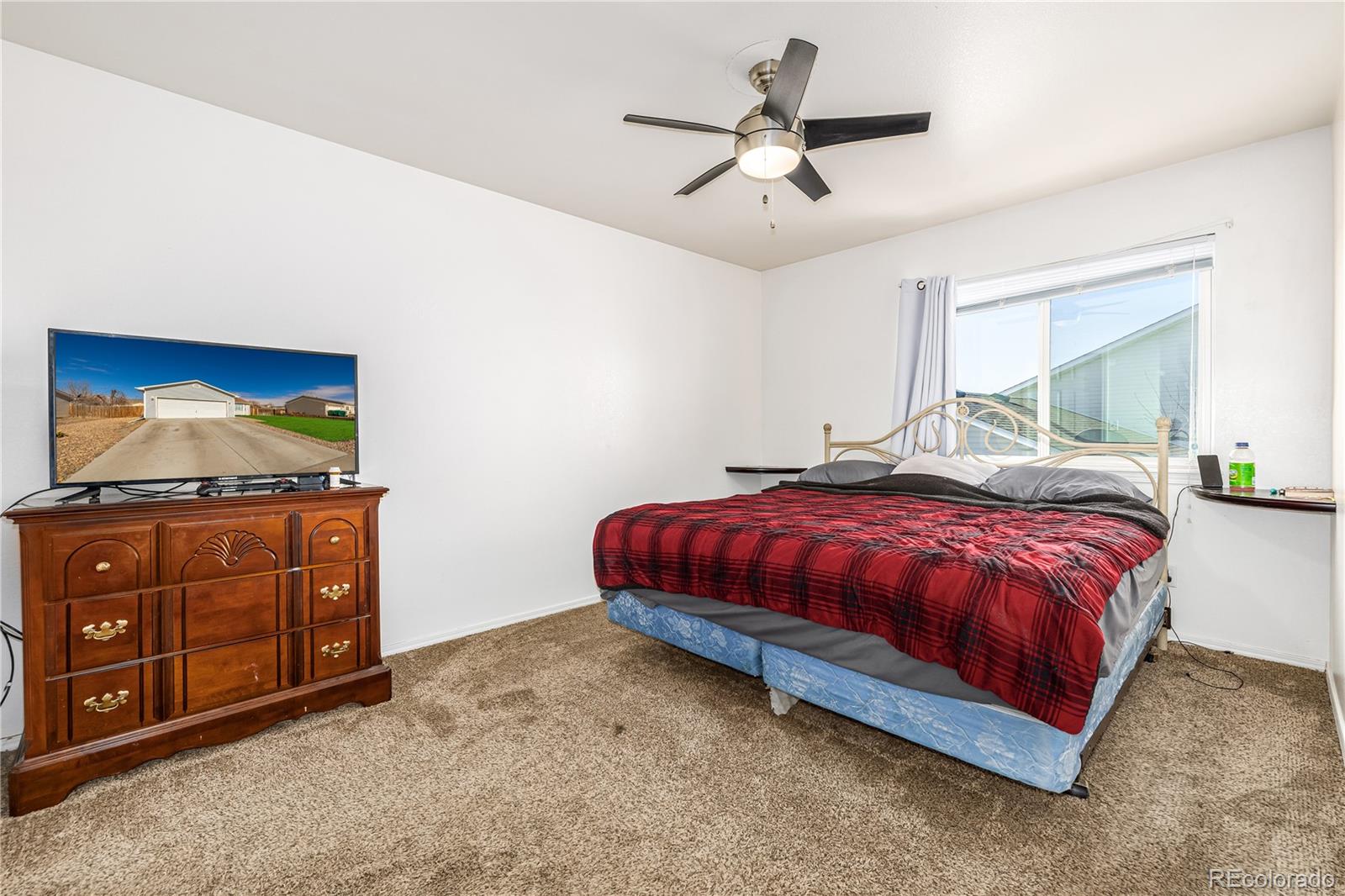 4005 Eagles Nest Drive Evans, CO 80620 - Photo 11 of 26 a spacious bedroom with a bed and a dresser