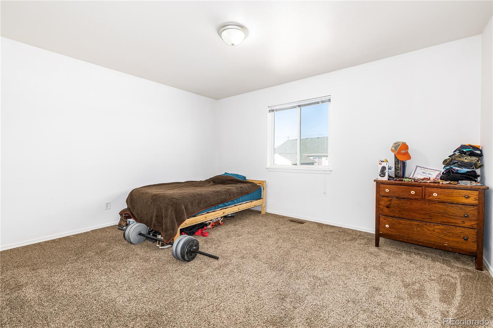 4005 Eagles Nest Drive Evans, CO 80620 - Photo 12 of 26 a room with a dresser and a window