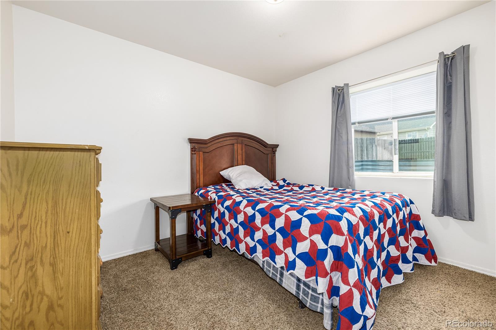 4005 Eagles Nest Drive Evans, CO 80620 - Photo 15 of 26 a bedroom with a bed and window