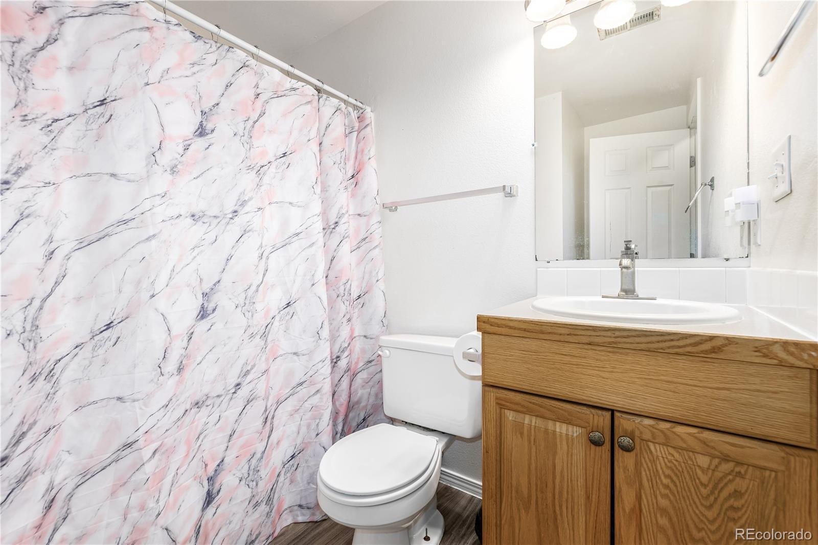 4005 Eagles Nest Drive Evans, CO 80620 - Photo 16 of 26 a bathroom with a granite countertop toilet sink and mirror