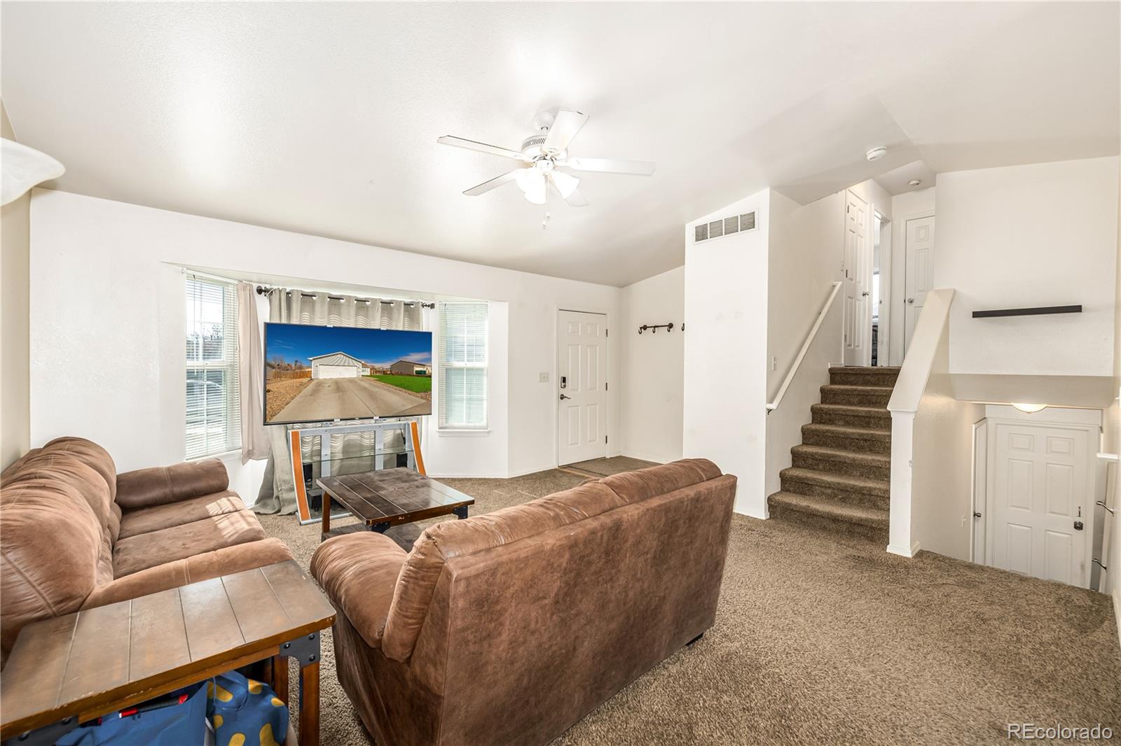 4005 Eagles Nest Drive Evans, CO 80620 - Photo 3 of 26 a living room with furniture and a ceiling fan