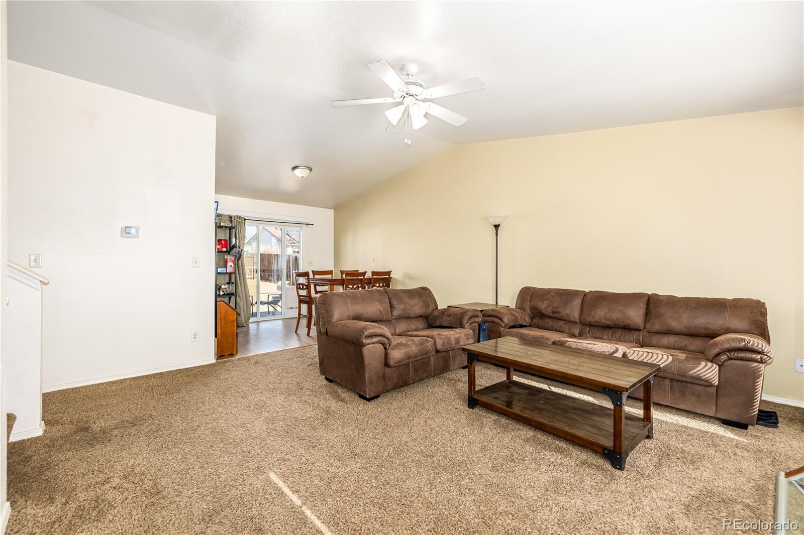 4005 Eagles Nest Drive Evans, CO 80620 - Photo 4 of 26 a living room with furniture and a chandelier