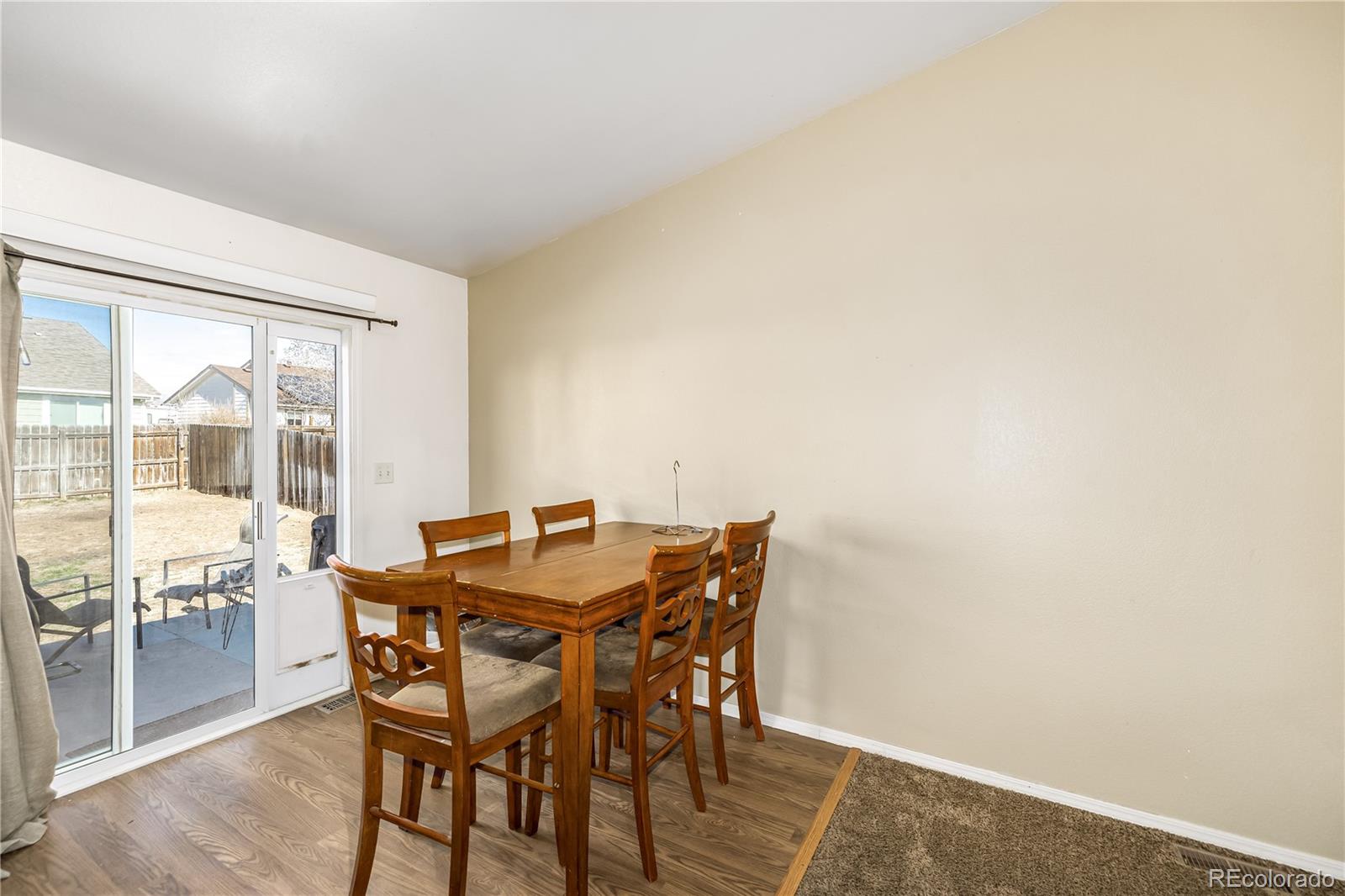 4005 Eagles Nest Drive Evans, CO 80620 - Photo 6 of 26 a view of a dining room with furniture and wooden floor