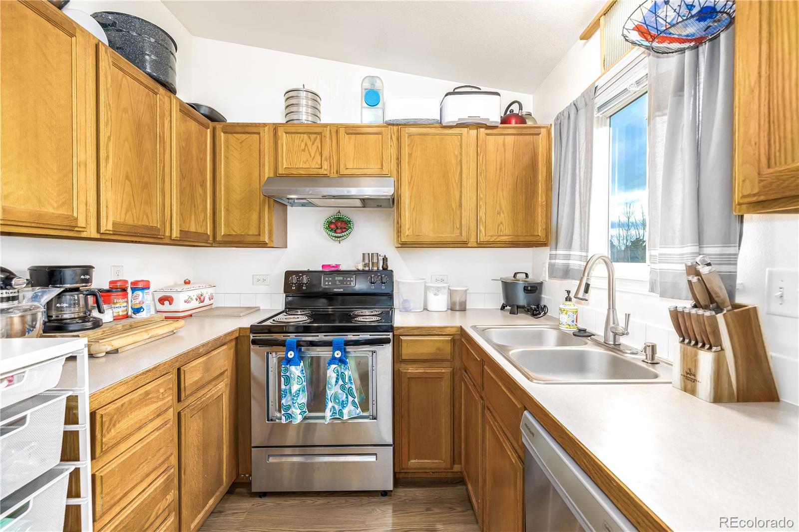 4005 Eagles Nest Drive Evans, CO 80620 - Photo 8 of 26 a kitchen with stainless steel appliances a sink a stove and a refrigerator