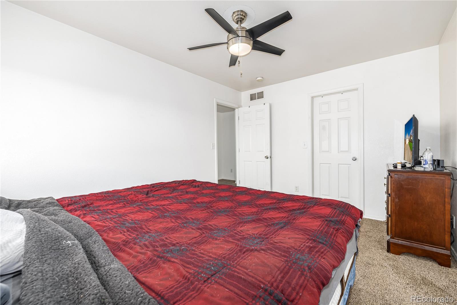 4005 Eagles Nest Drive Evans, CO 80620 - Photo 10 of 26 a bedroom with a bed and a dresser in it