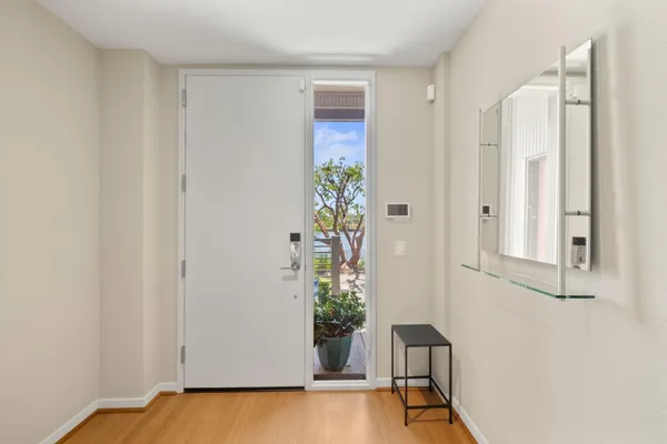 a view of an entryway with wooden floor