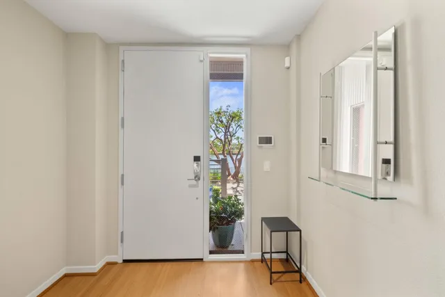 a view of an entryway with wooden floor