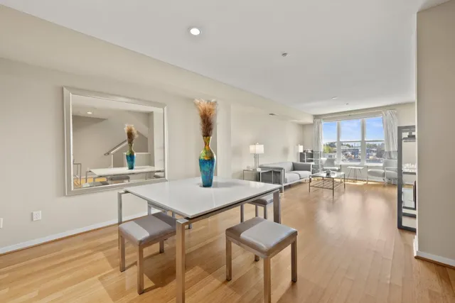 a view of a dining room with furniture and wooden floor