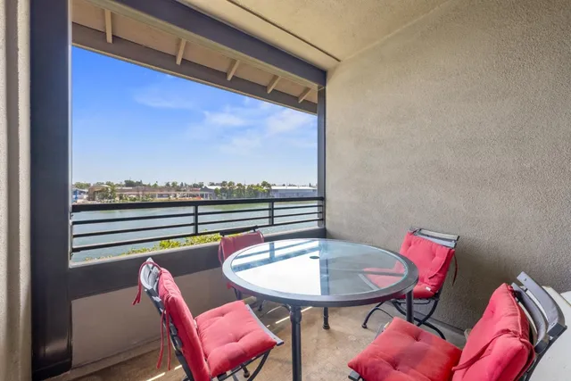 a balcony with a table and chairs