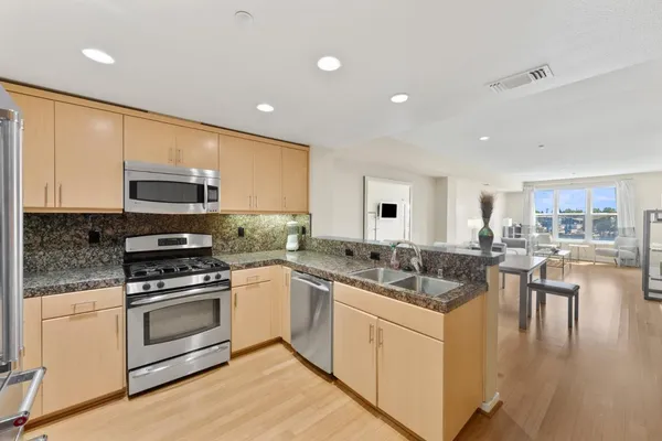 a kitchen with a stove a sink and a microwave