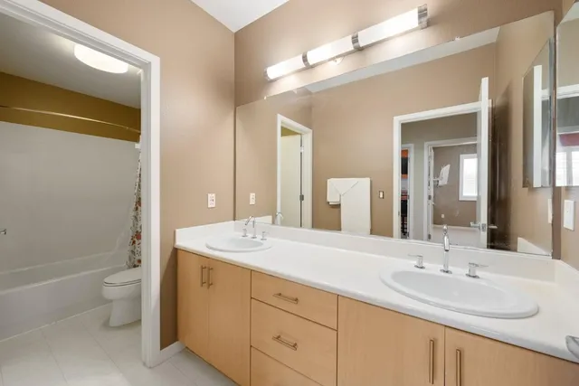 a bathroom with a sink double vanity and a mirror