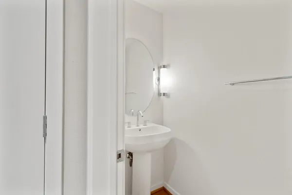 a bathroom with a sink a mirror and a shower