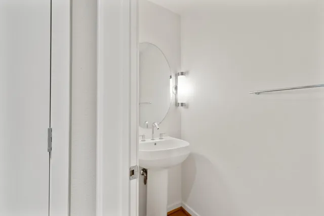 a bathroom with a sink a mirror and a shower