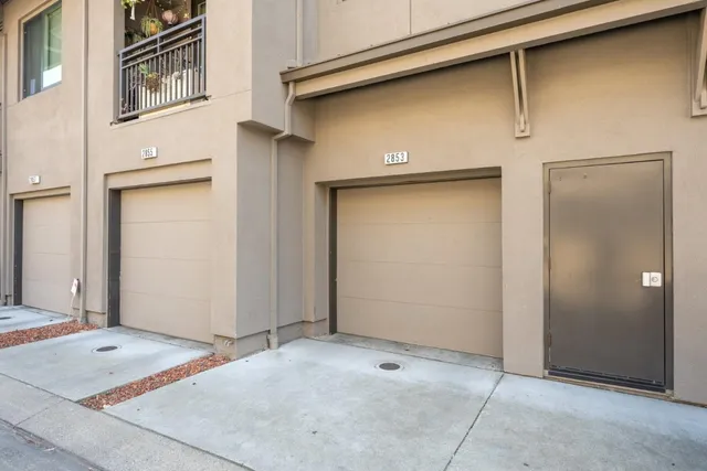 a row of palm trees in front of a house