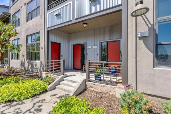 a front view of a house with a yard outdoor seating and garage