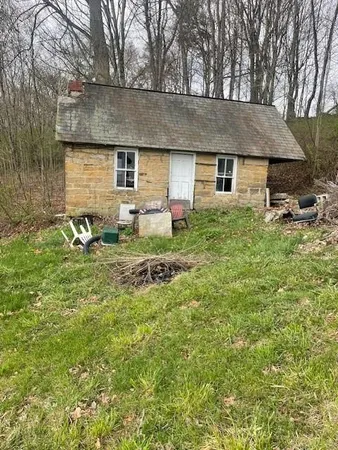 a backyard of a house with table and chairs