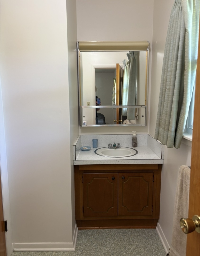 609 9th Avenue Ottawa, IL 61350 - Photo 17 of 28 a bathroom with a sink and a mirror