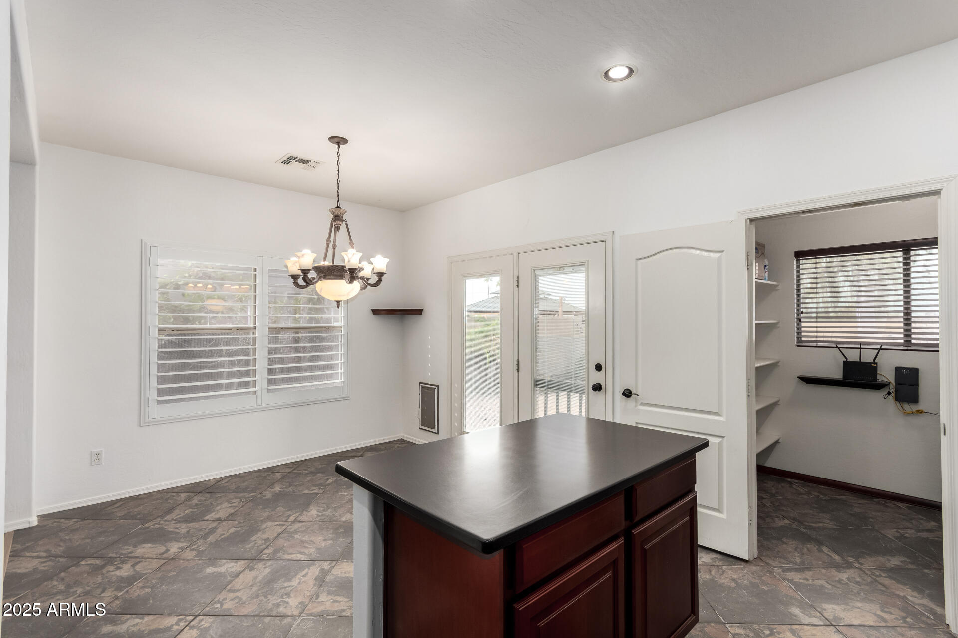 1126 East Pedro Road Phoenix, AZ 85042 - Photo 11 of 34 a hallway with a stove a faucet a chandelier and living room view