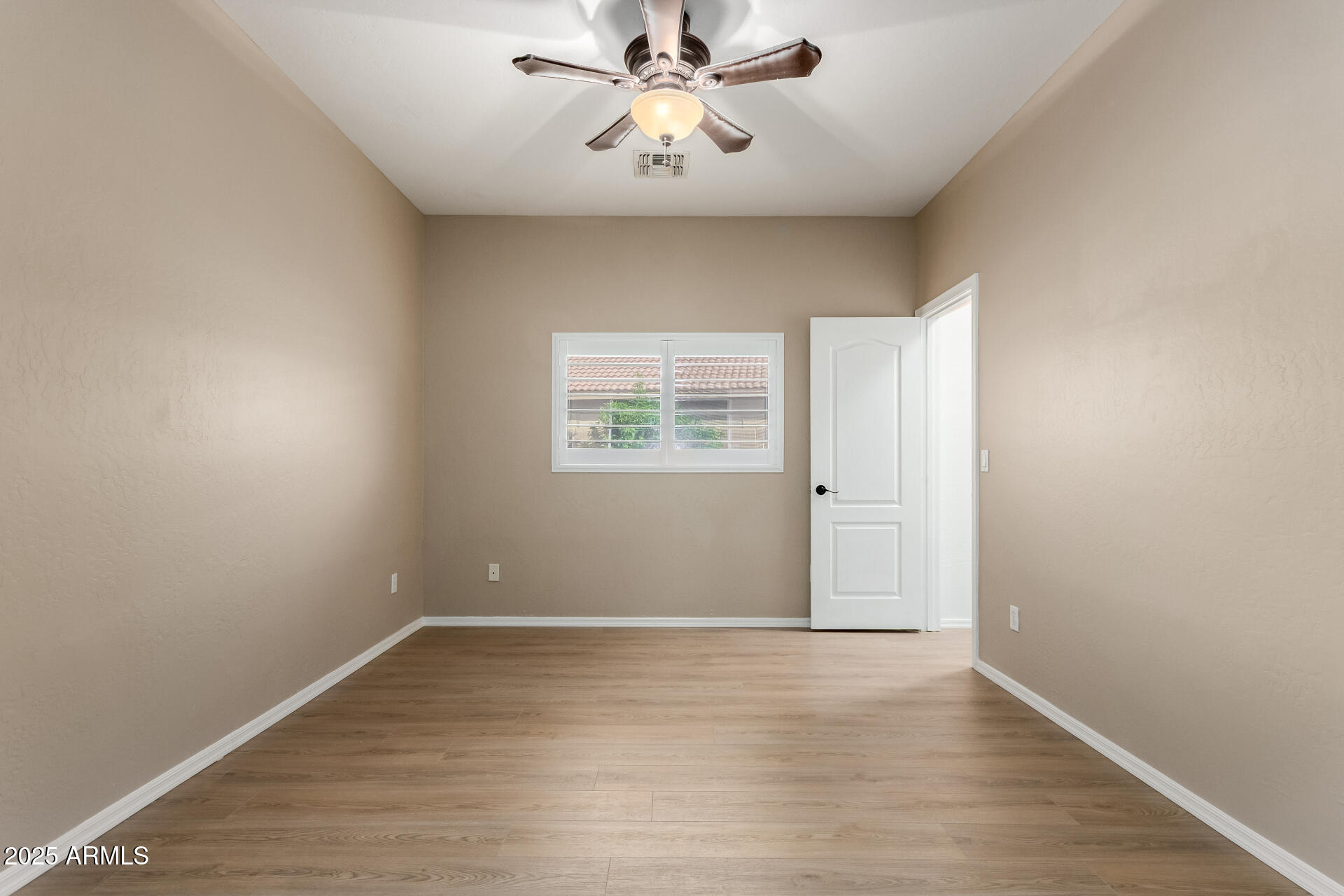 1126 East Pedro Road Phoenix, AZ 85042 - Photo 18 of 34 wooden floor in an empty room with a window